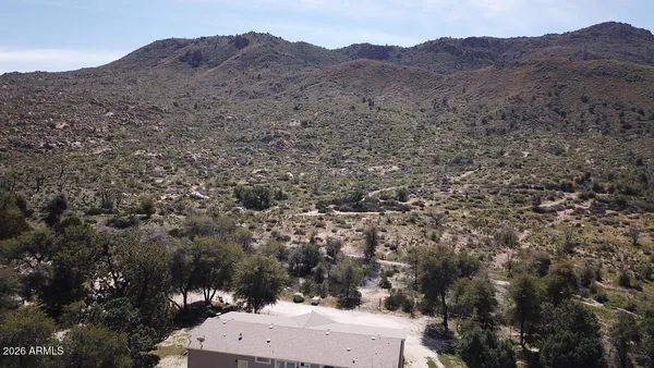 a view of a house with a mountain and trees