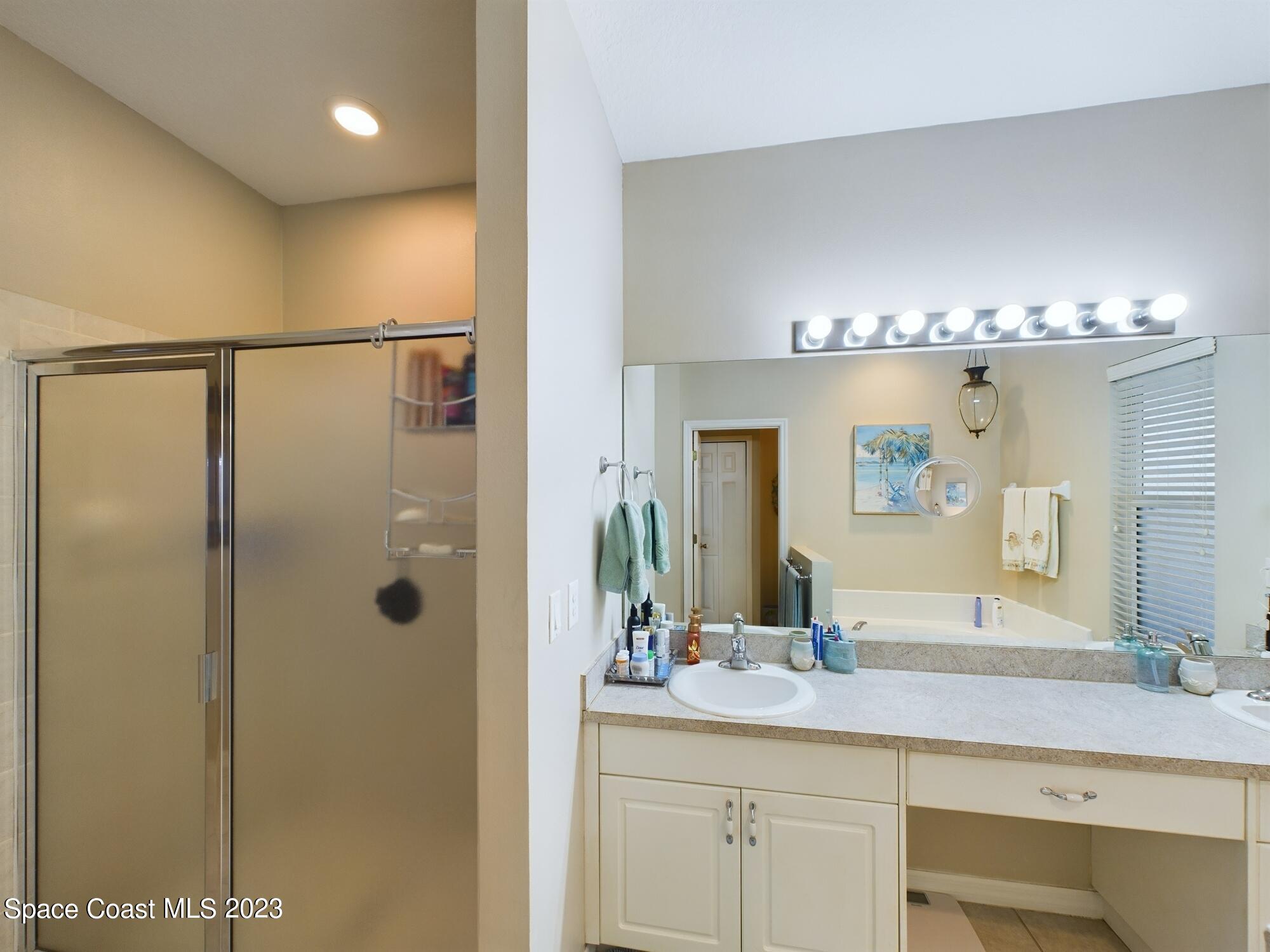 4630 Paladin Circle Vero Beach, FL 32967 - Photo 9 of 33 a bathroom with a double vanity sink and mirror