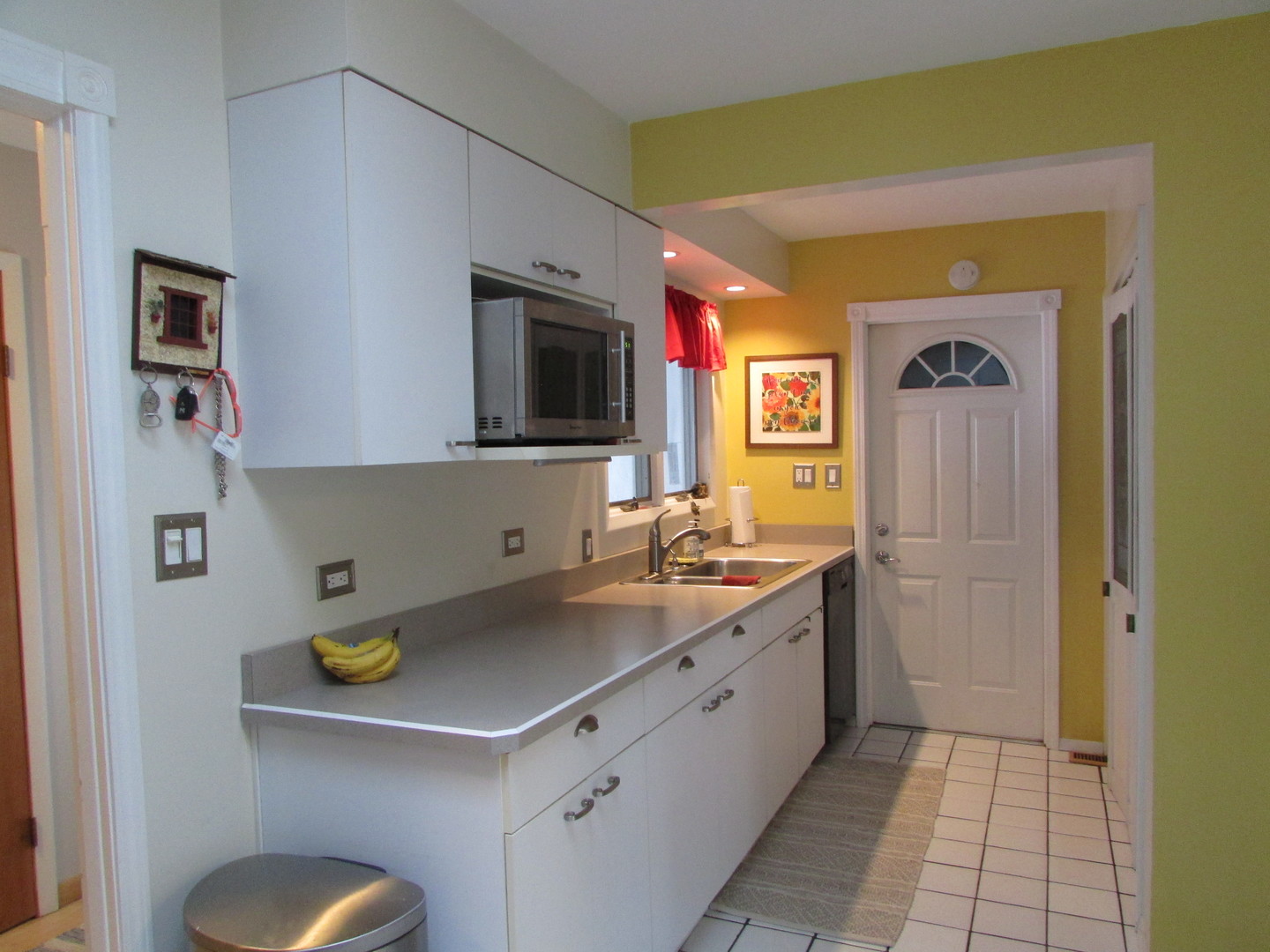 21W255 Canary Road Lombard, IL 60148 - Photo 14 of 32 a kitchen with a sink a stove and cabinets