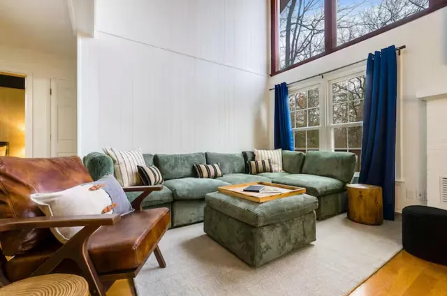 a bedroom with a bed and a lamp next to a window