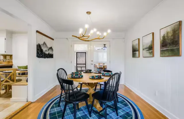 a dining room with furniture and wooden floor