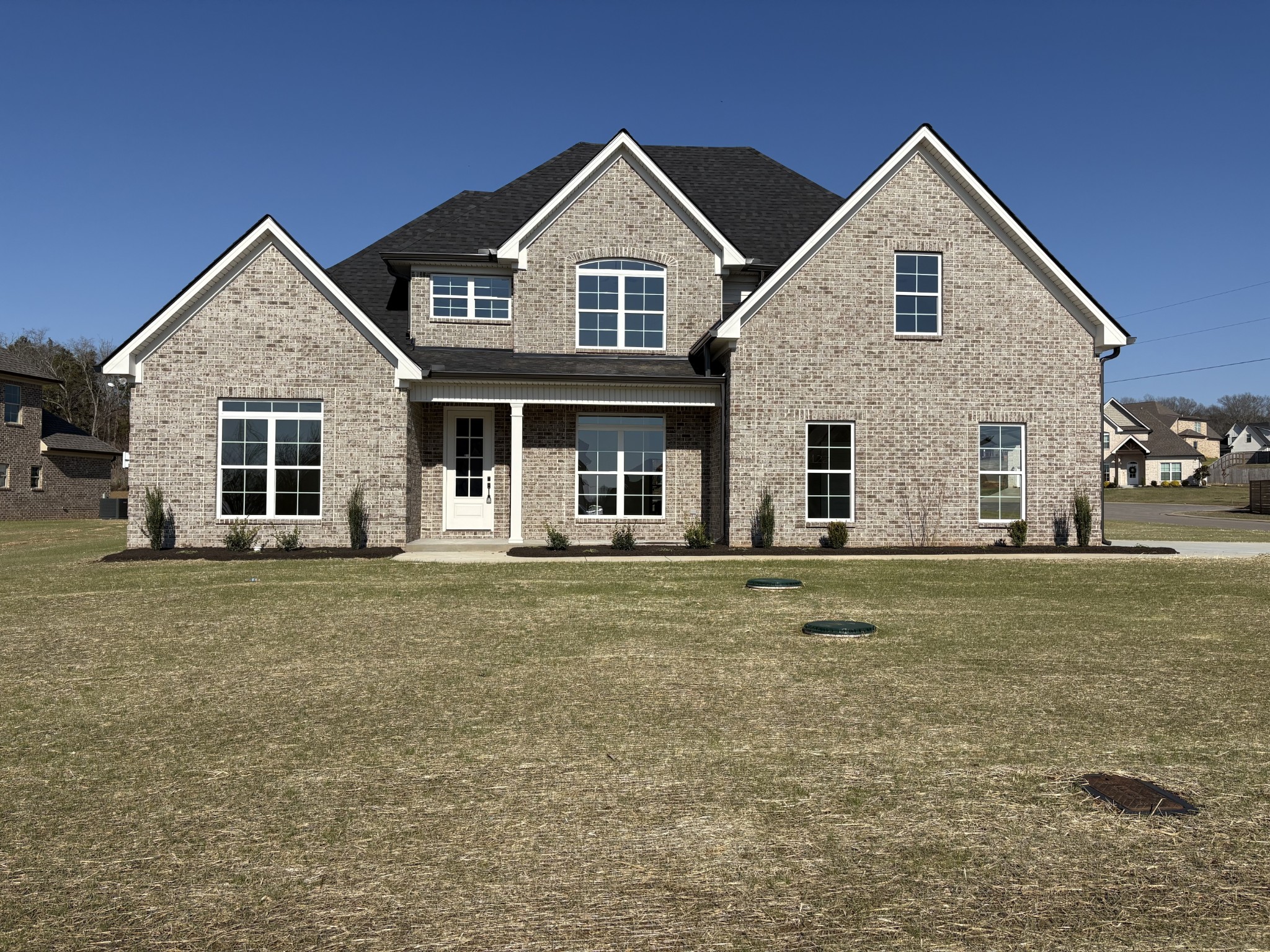 a front view of a house with a garden