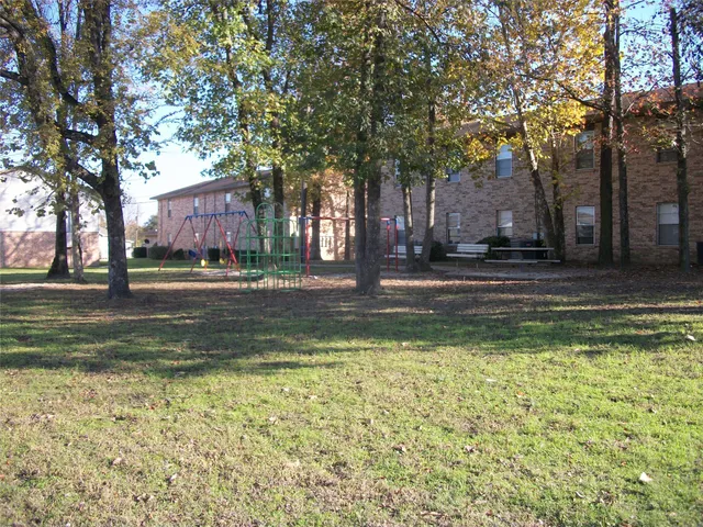 a view of pool with trees in the background