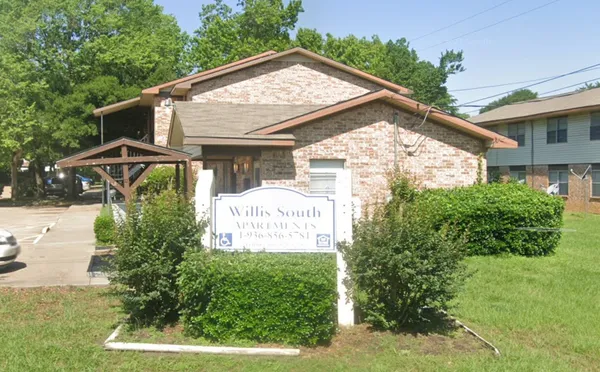 a view of a house with a yard and plants