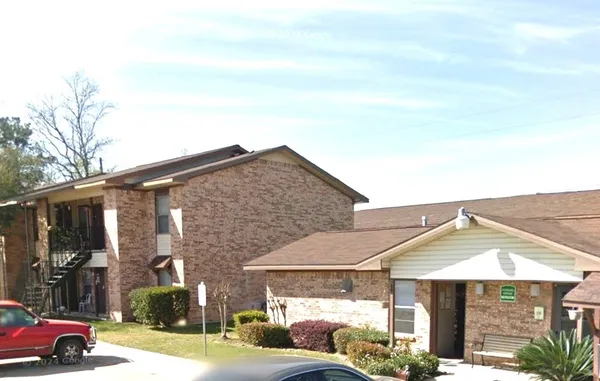 a car parked in front of white house
