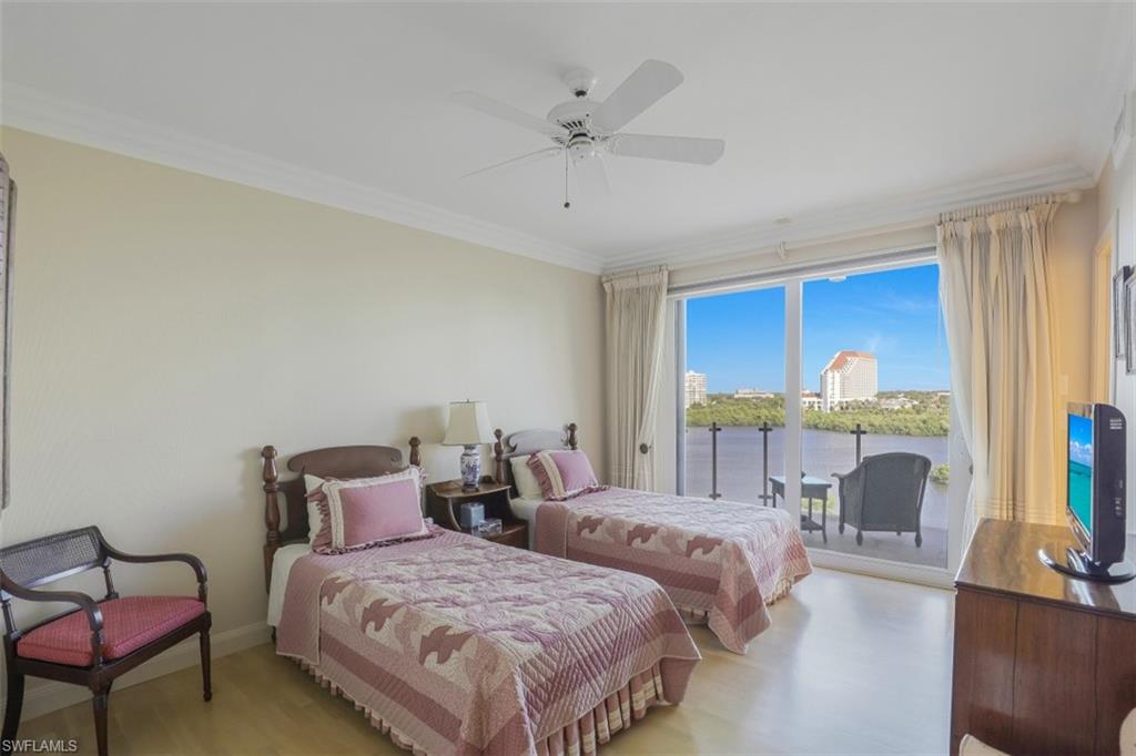 10 Seagate Drive, Unit 6S Naples, FL 34103 - Photo 23 of 34 a bedroom with two beds and a large window