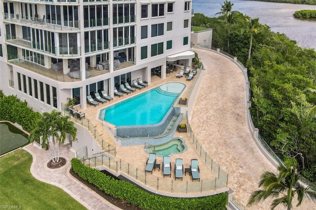 10 Seagate Drive, Unit 6S Naples, FL 34103 - Photo 29 of 34 a view of a swimming pool with a garden
