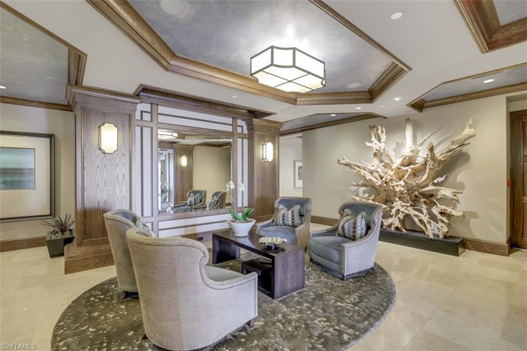 10 Seagate Drive, Unit 6S Naples, FL 34103 - Photo 32 of 34 a living room with furniture and a chandelier