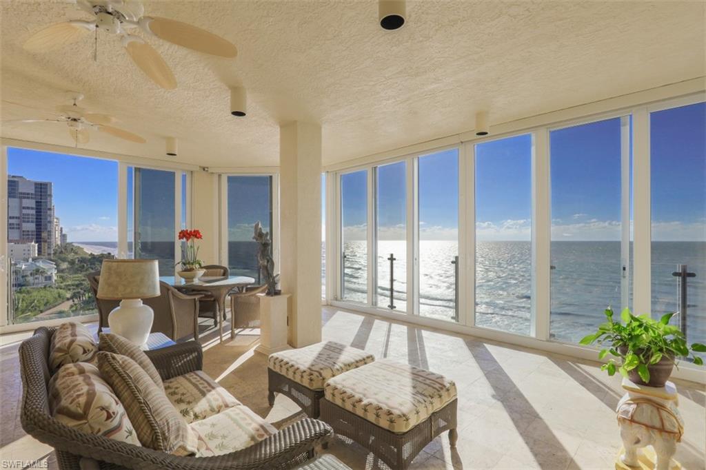 10 Seagate Drive, Unit 6S Naples, FL 34103 - Photo 8 of 34 a living room with furniture and a floor to ceiling window
