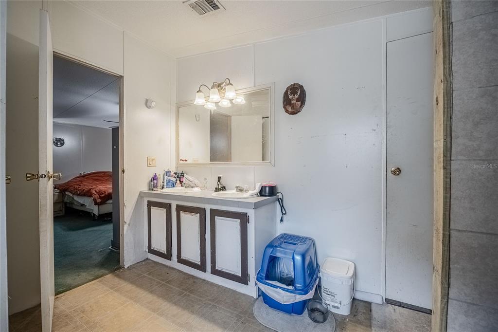 194 North Lake Patrick Road Babson Park, FL 33827 - Photo 15 of 31 a en suite bathroom with a toilet sink and mirror
