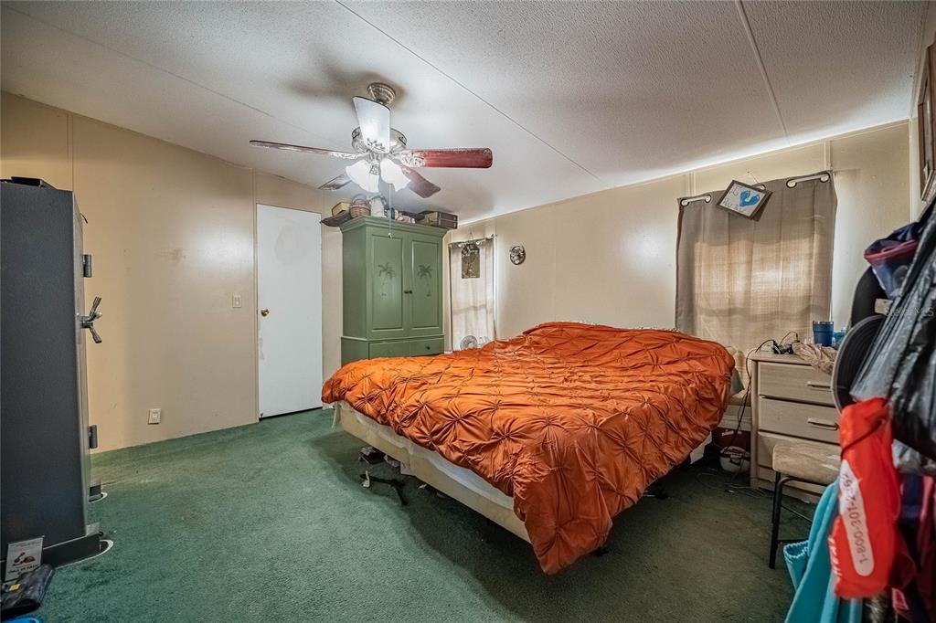 194 North Lake Patrick Road Babson Park, FL 33827 - Photo 16 of 31 a bed sitting in a room next to a window and a chandelier