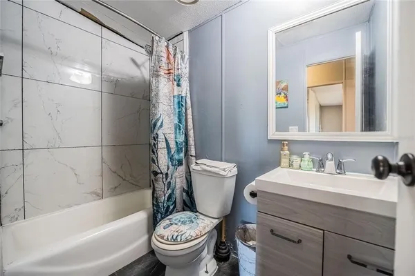 a bathroom with a sink toilet and a mirror