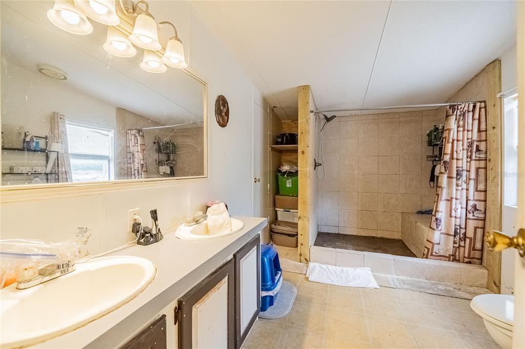 194 North Lake Patrick Road Babson Park, FL 33827 - Photo 21 of 31 a bathroom with a sink double vanity and shower