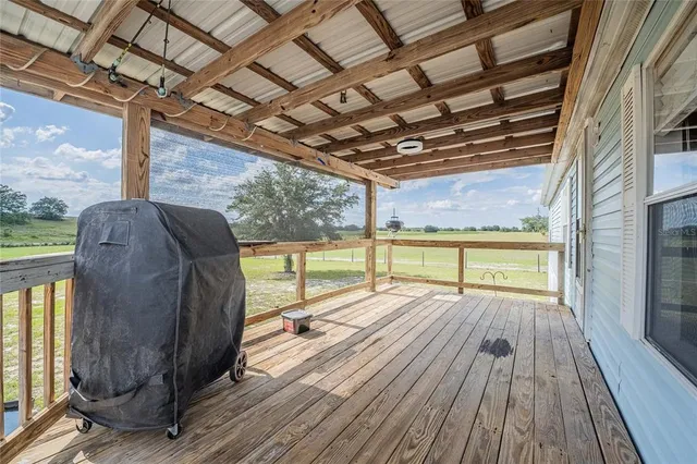 a kitchen with stainless steel appliances a dining table chairs stove refrigerator and cabinets