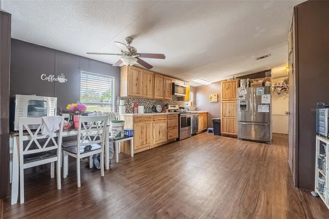 a kitchen with stainless steel appliances granite countertop a stove a sink and a refrigerator