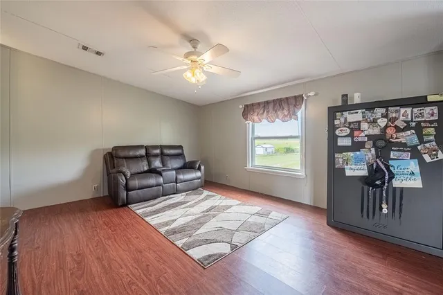 a view of a livingroom with furniture and wooden floor