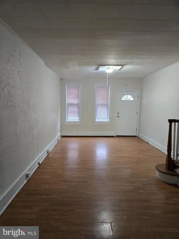 a view of room with window and wooden floor