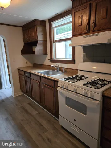 a kitchen with stainless steel appliances a stove a sink and a microwave