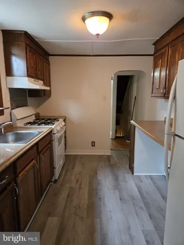 a kitchen with granite countertop a stove and a refrigerator