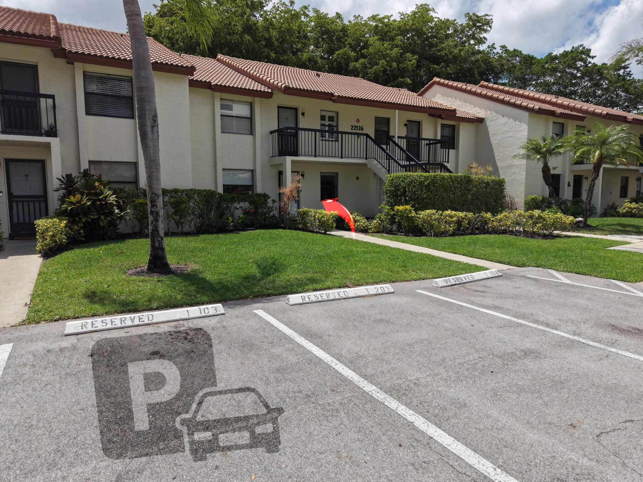 22136 Palms Way, Unit 103 Boca Raton, FL 33433 - Photo 37 of 42 front view of a house with a yard