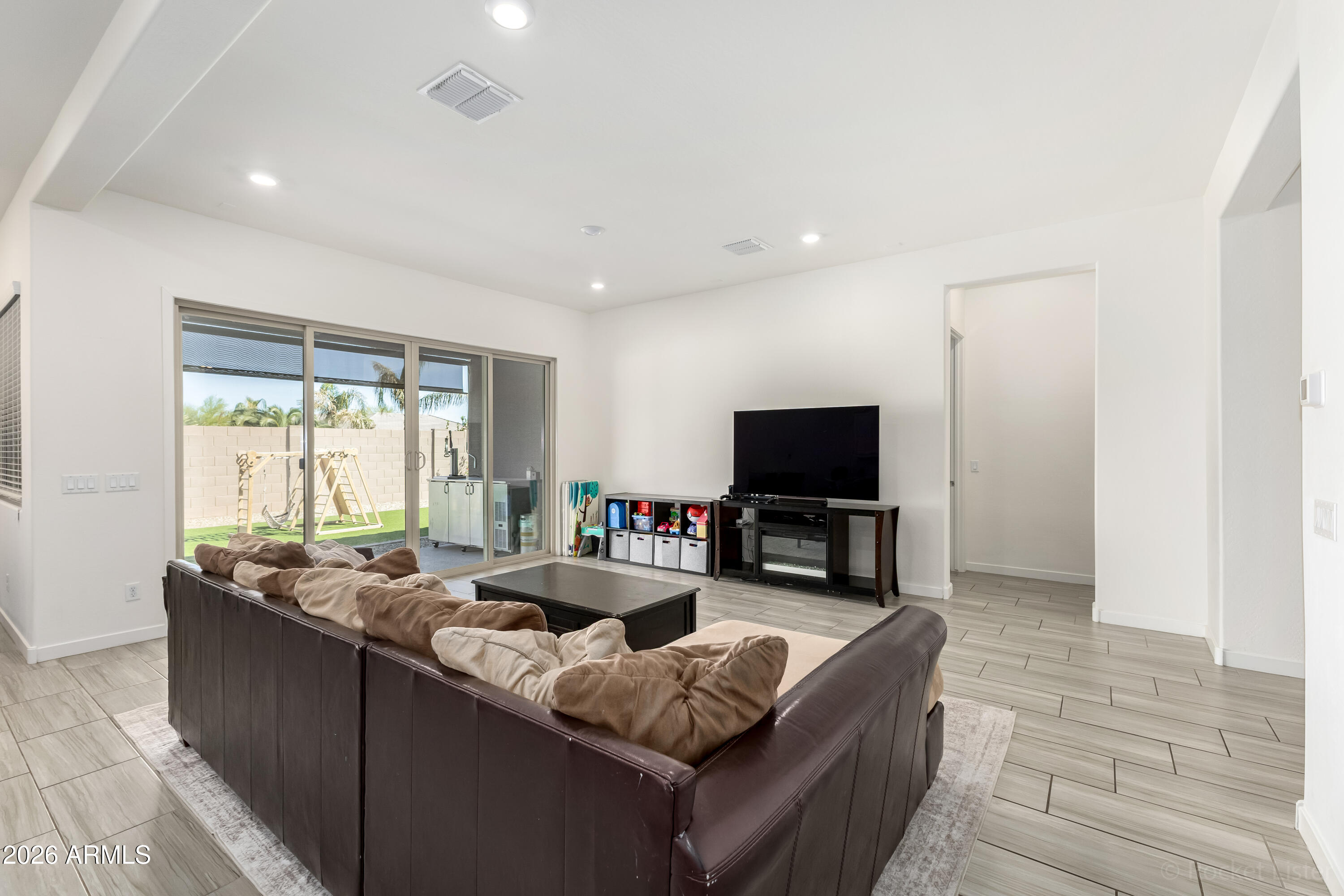 23929 North 166th Lane Surprise, AZ 85387 - Photo 4 of 23 a living room with furniture and a flat screen tv