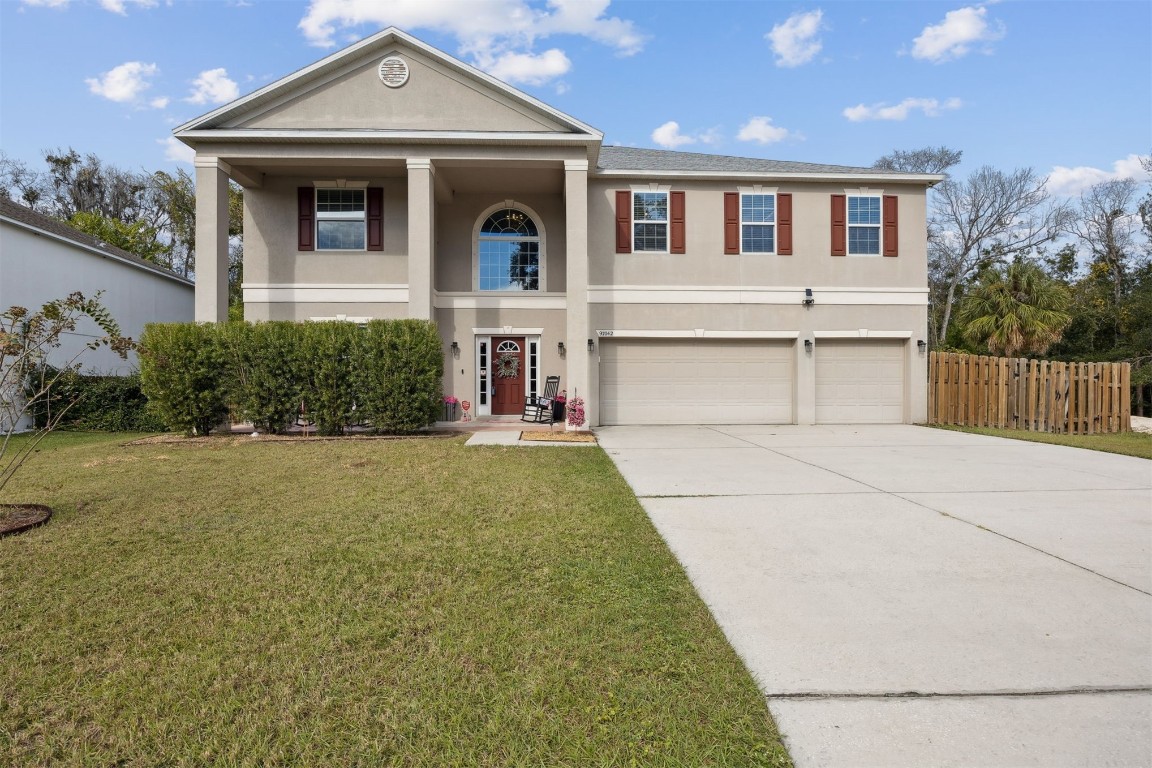a front view of a house with a yard and garage