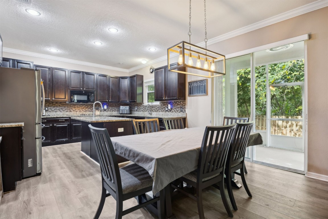 97042 Huntington Court Yulee, FL 32097 - Photo 16 of 54 a view of a dining room and livingroom with furniture wooden floor a chandelier