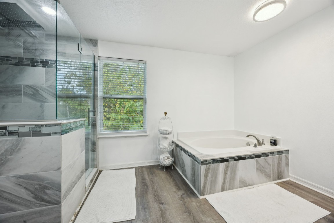 97042 Huntington Court Yulee, FL 32097 - Photo 19 of 54 a bath room with a bath tub and a shower