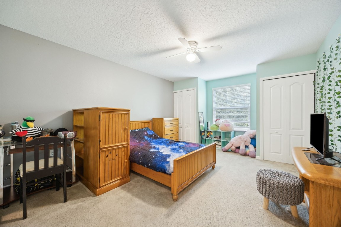 97042 Huntington Court Yulee, FL 32097 - Photo 27 of 54 a bedroom with a bed and a flat screen tv