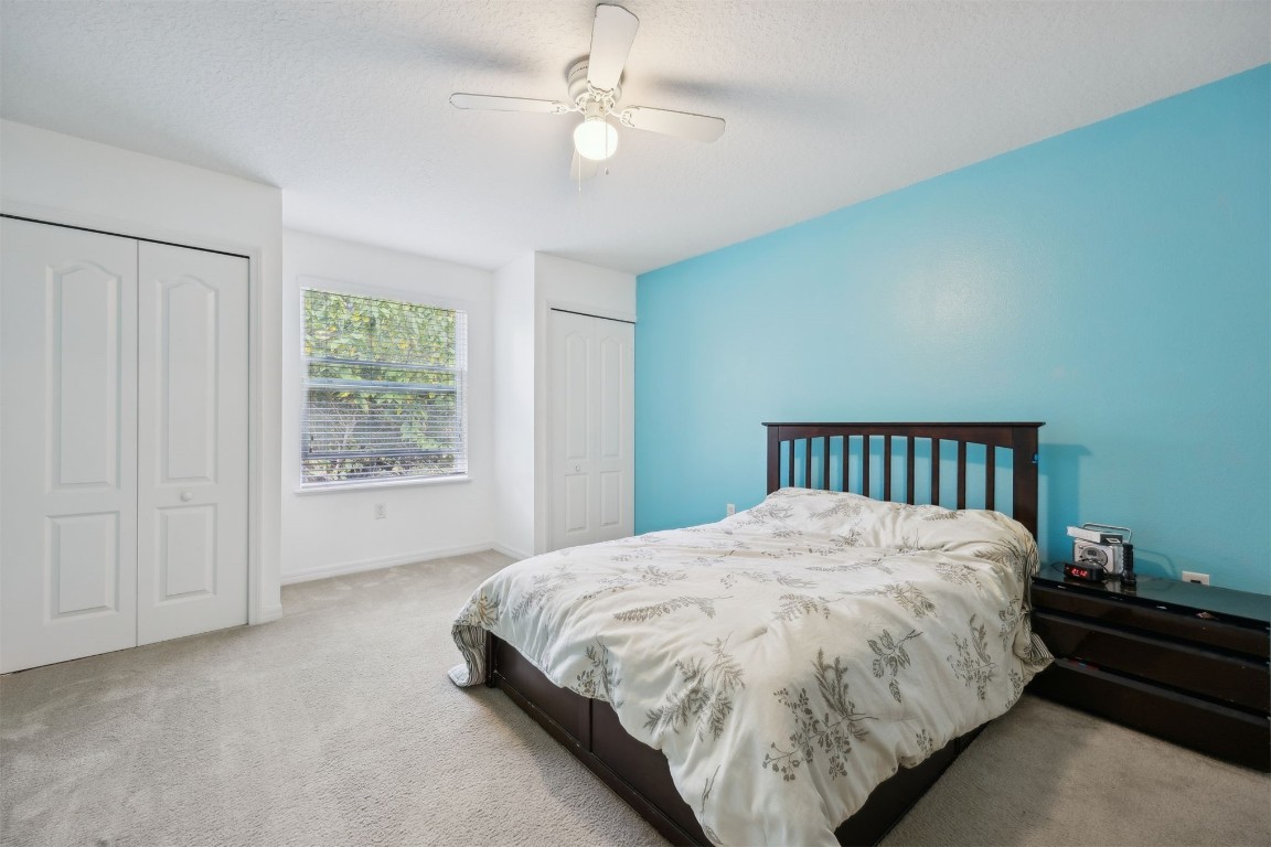 97042 Huntington Court Yulee, FL 32097 - Photo 29 of 54 a bed sitting in a spacious bedroom next to a window