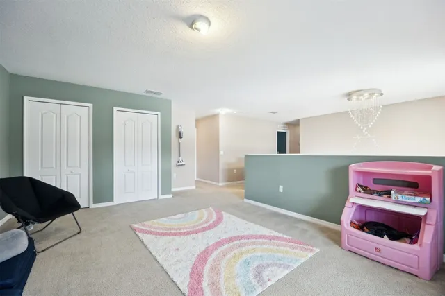 a bedroom with furniture and a flat screen tv
