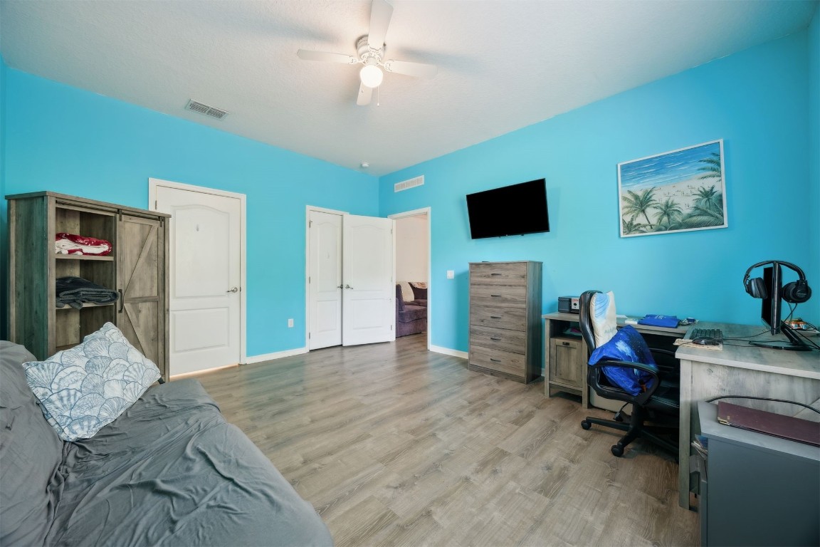 97042 Huntington Court Yulee, FL 32097 - Photo 36 of 54 a bedroom with furniture and a flat screen tv