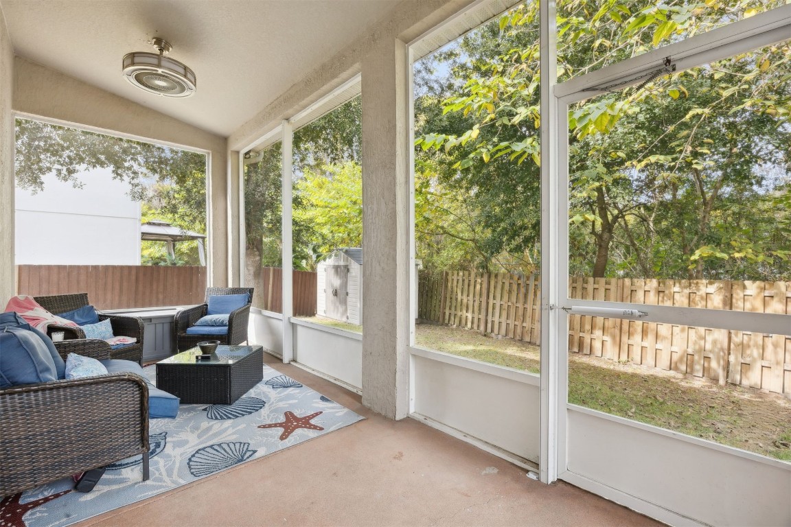 97042 Huntington Court Yulee, FL 32097 - Photo 39 of 54 a living room with furniture and a floor to ceiling window