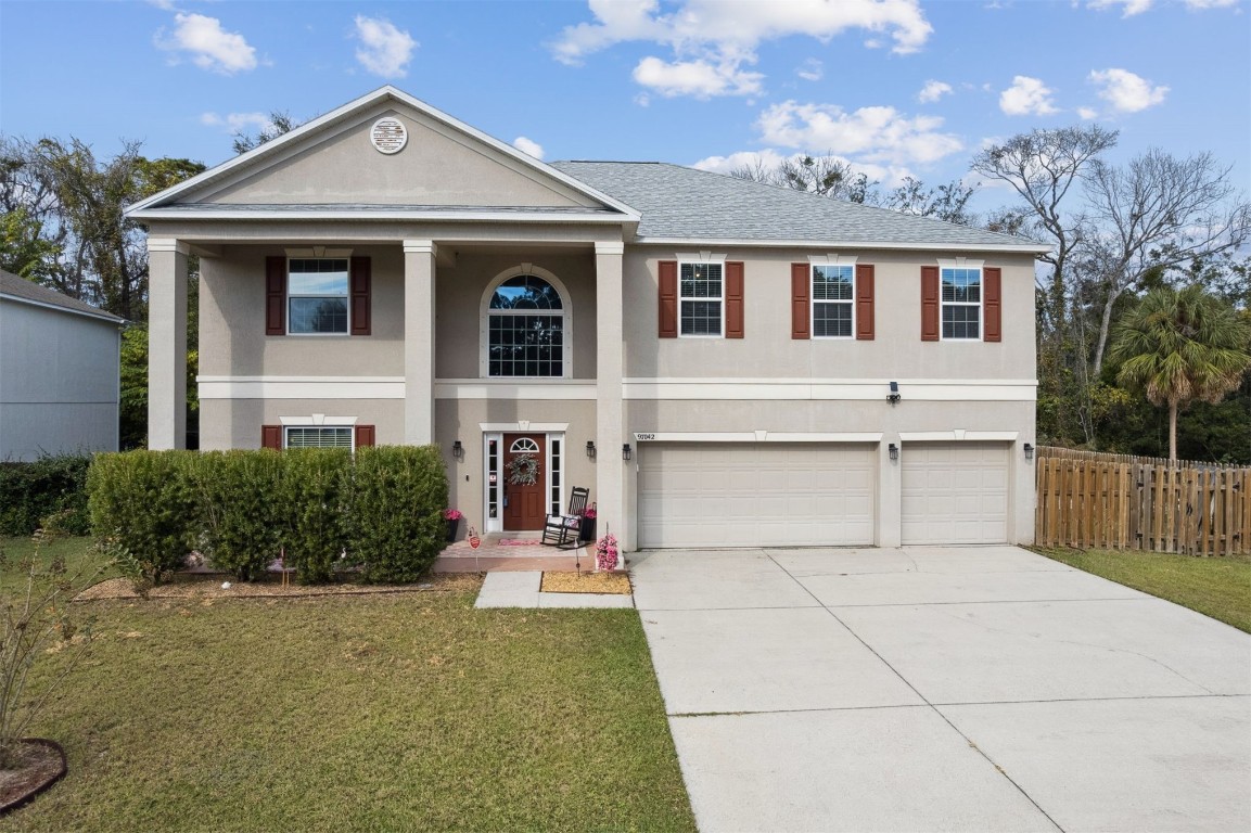 97042 Huntington Court Yulee, FL 32097 - Photo 45 of 54 a front view of a house with a garden
