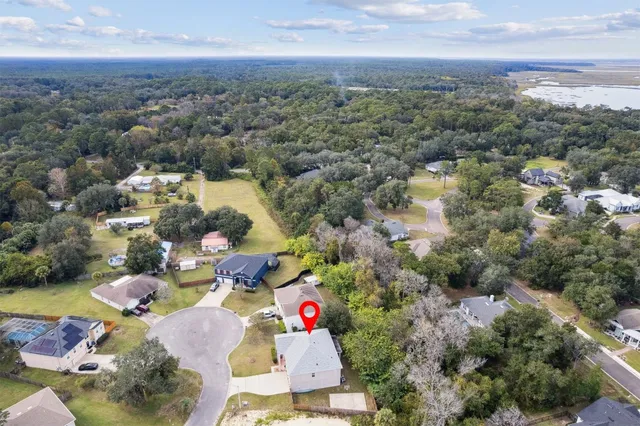 an aerial view of a house with yard and outdoor seating
