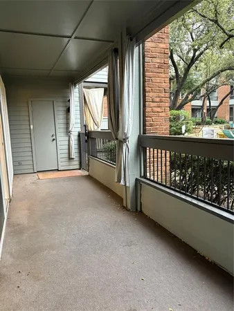 a view of a porch with wooden floor and iron fence
