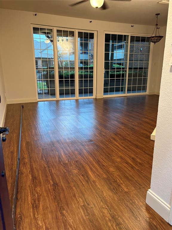1720 Northeast Green Oaks Boulevard, Unit 104 Arlington, TX 76006 - Photo 2 of 13 wooden floor in an empty room with a window
