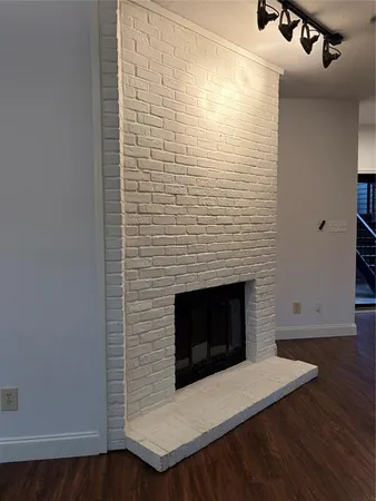 a room with a wooden floor and a fireplace