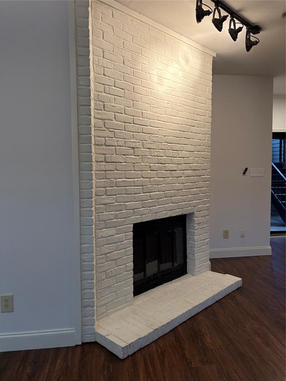1720 Northeast Green Oaks Boulevard, Unit 104 Arlington, TX 76006 - Photo 7 of 13 a room with a wooden floor and a fireplace