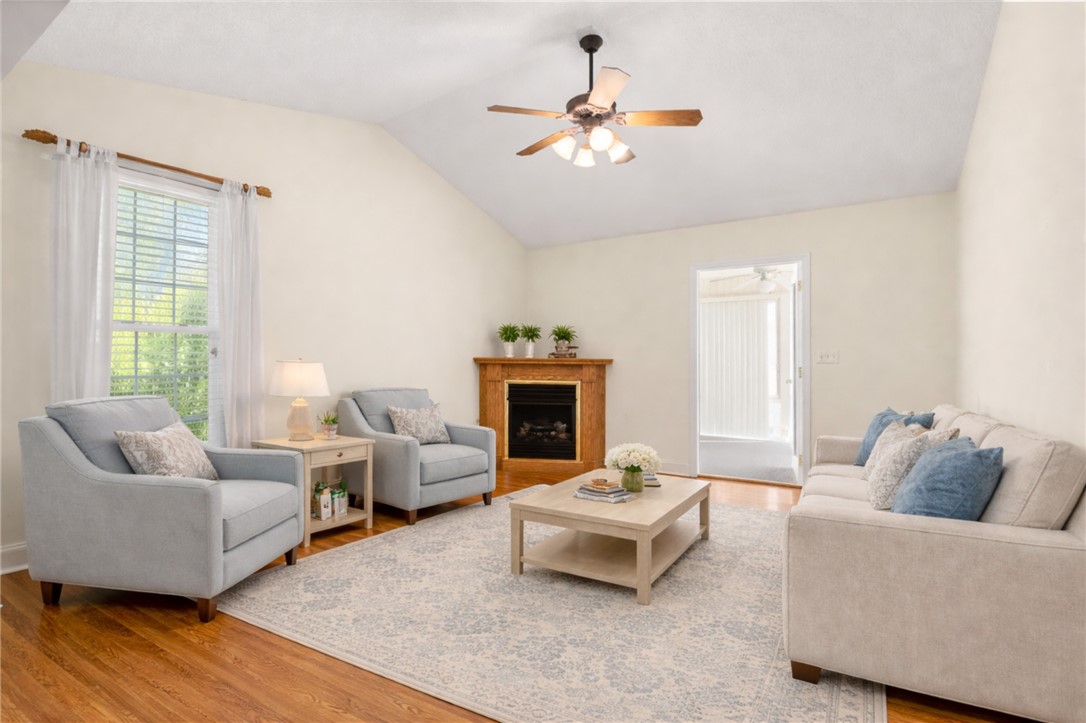 111 Park Way Anderson, SC 29625 - Photo 13 of 19 This inviting living room features warm wood flooring and a cozy corner fireplace.