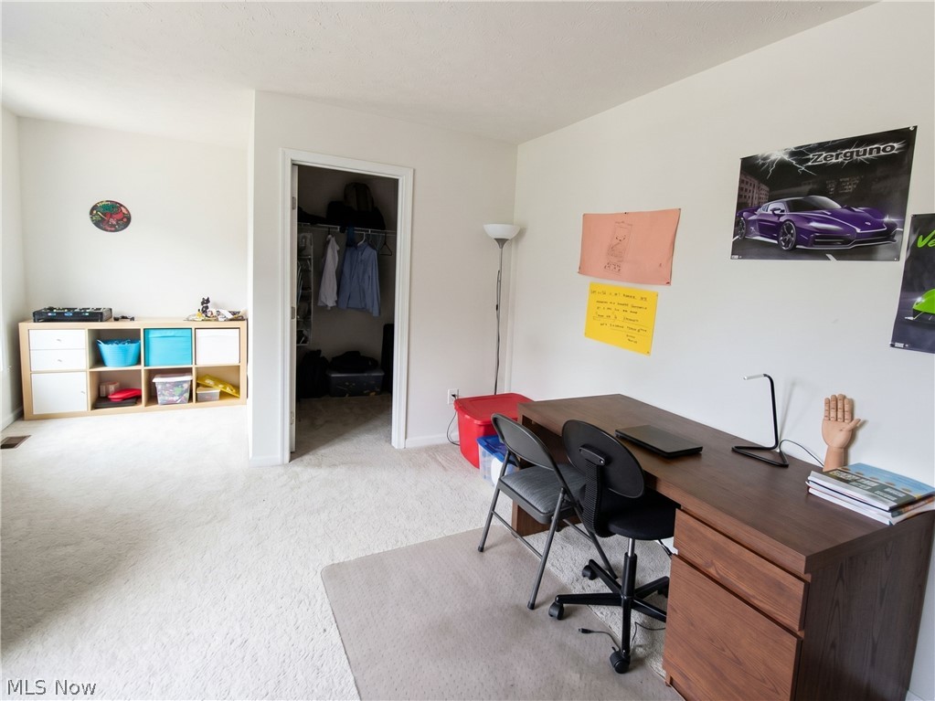 4509 Millbrook Way Akron, OH 44321 - Photo 22 of 27 Wall-to-wall carpeting throughout this interior space, featuring a neutral color palette