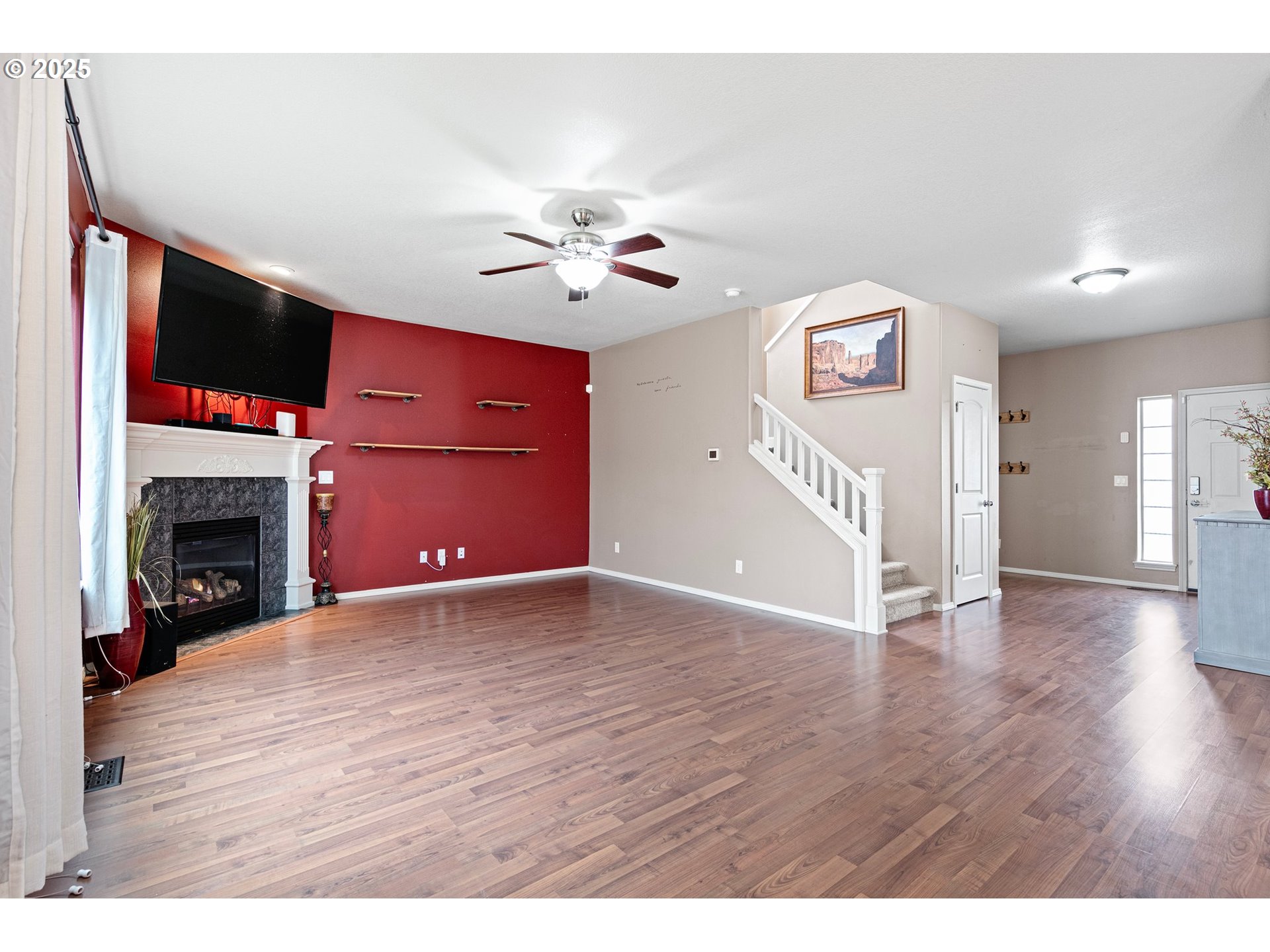 646 Raber Road Eugene, OR 97402 - Photo 11 of 44 a view of an empty room with a fireplace and wooden floor