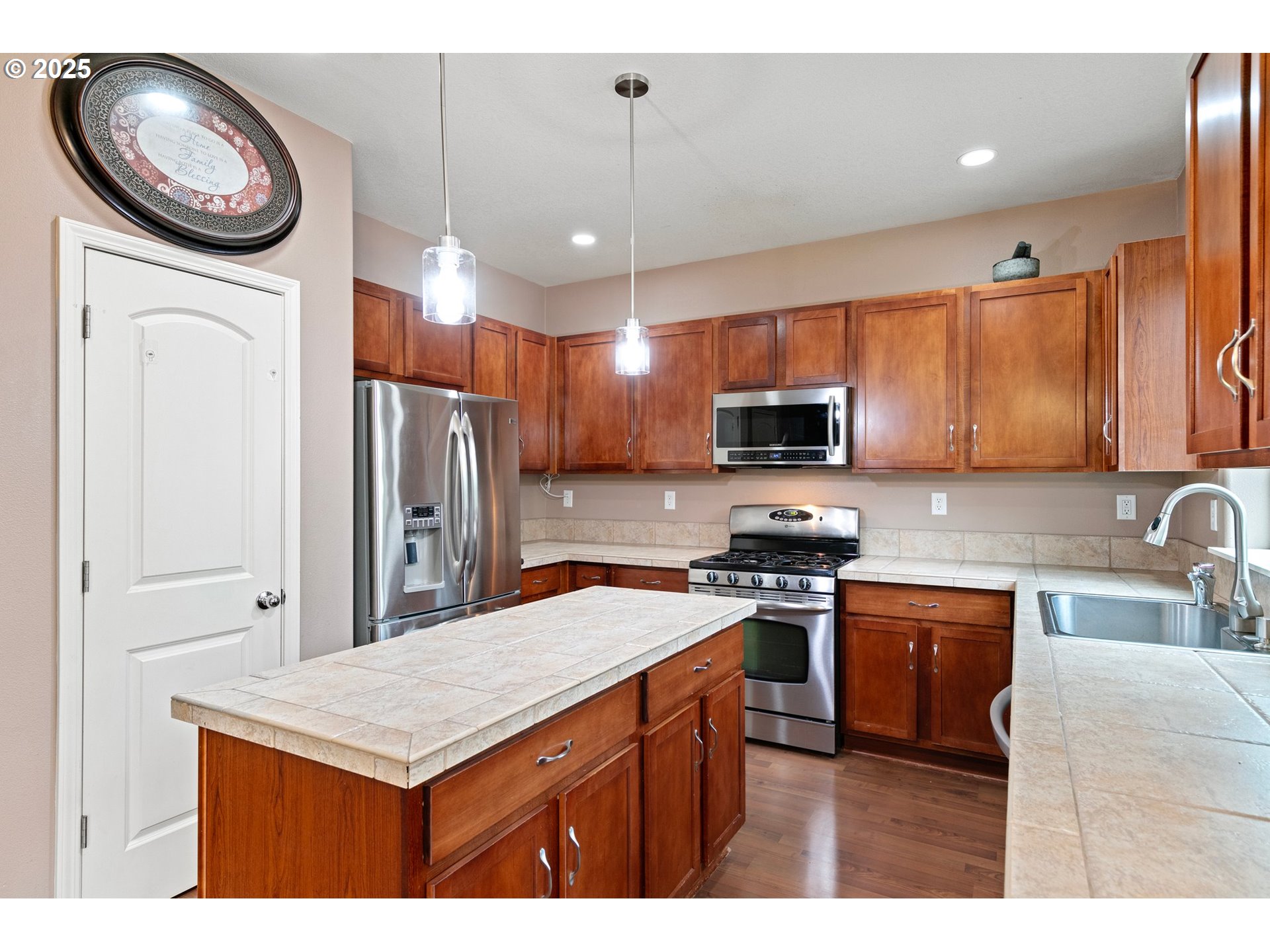 646 Raber Road Eugene, OR 97402 - Photo 12 of 44 a kitchen with stainless steel appliances granite countertop a sink a stove a refrigerator a washer and dryer