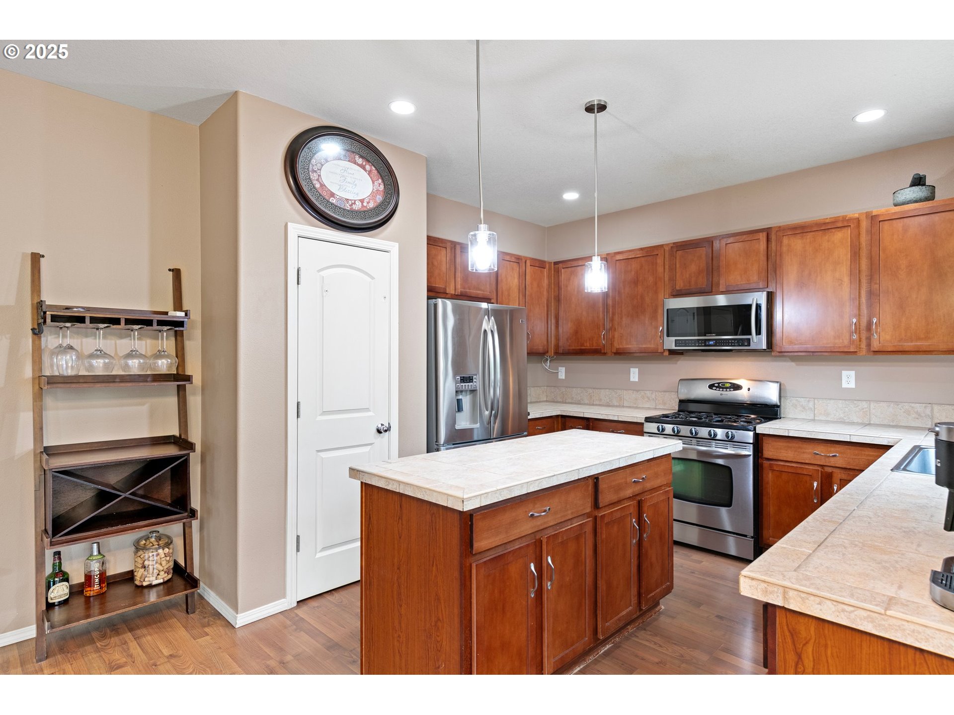 646 Raber Road Eugene, OR 97402 - Photo 17 of 44 a kitchen with a refrigerator a stove top oven a sink and cabinets