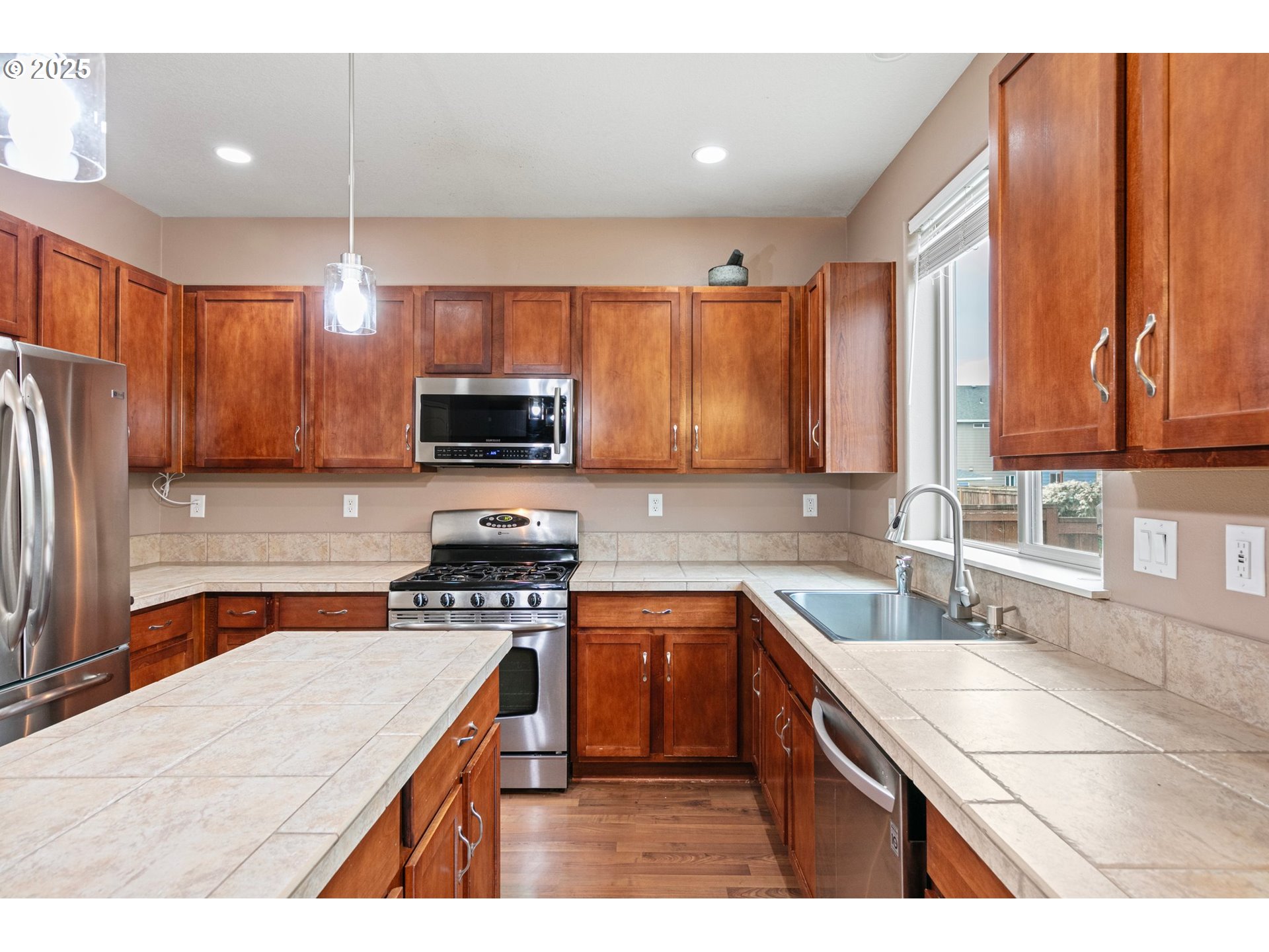 646 Raber Road Eugene, OR 97402 - Photo 18 of 44 a kitchen with stainless steel appliances granite countertop a sink stove microwave and refrigerator