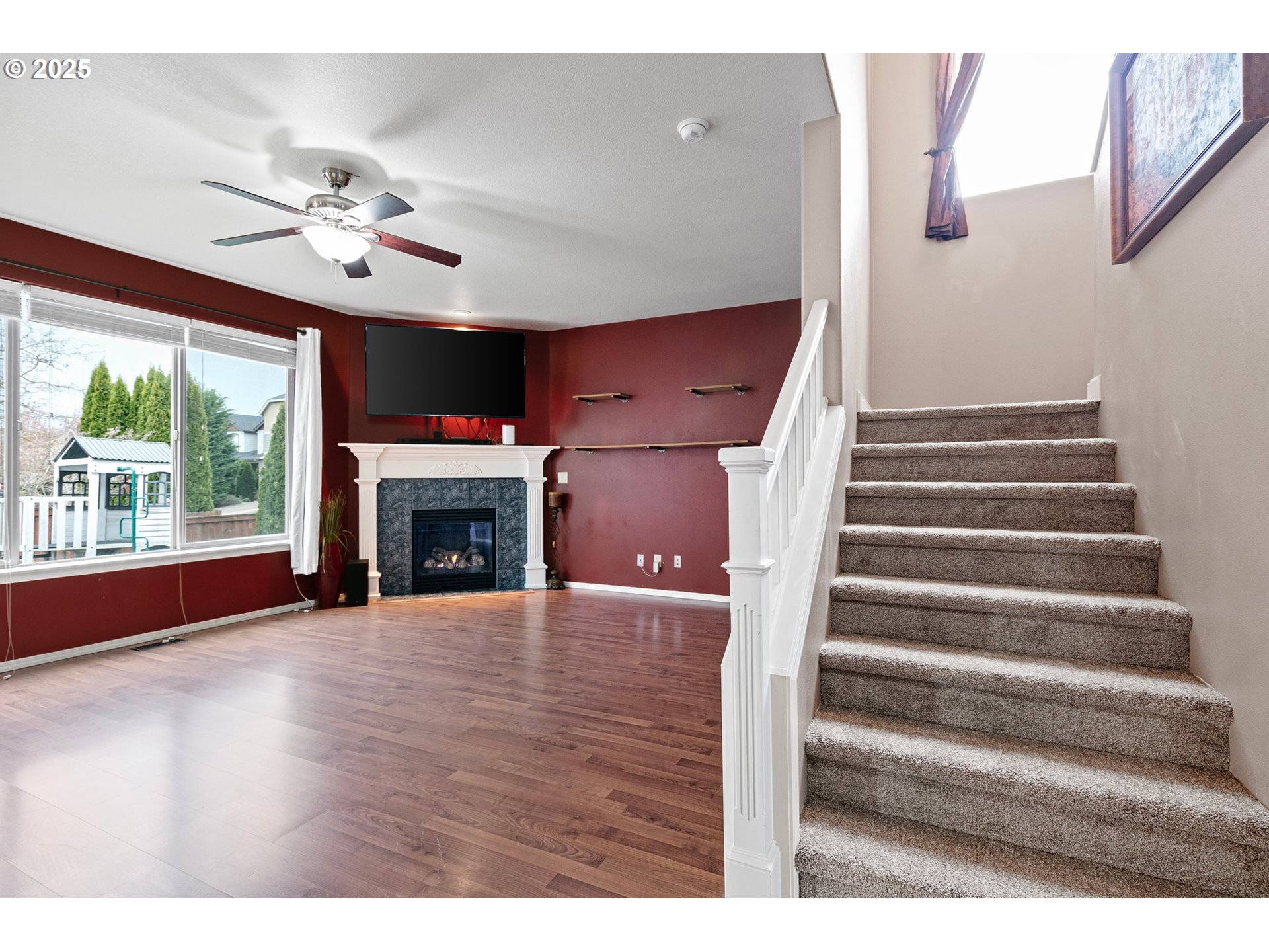 646 Raber Road Eugene, OR 97402 - Photo 8 of 44 a view of an empty room with wooden floor fireplace and a window