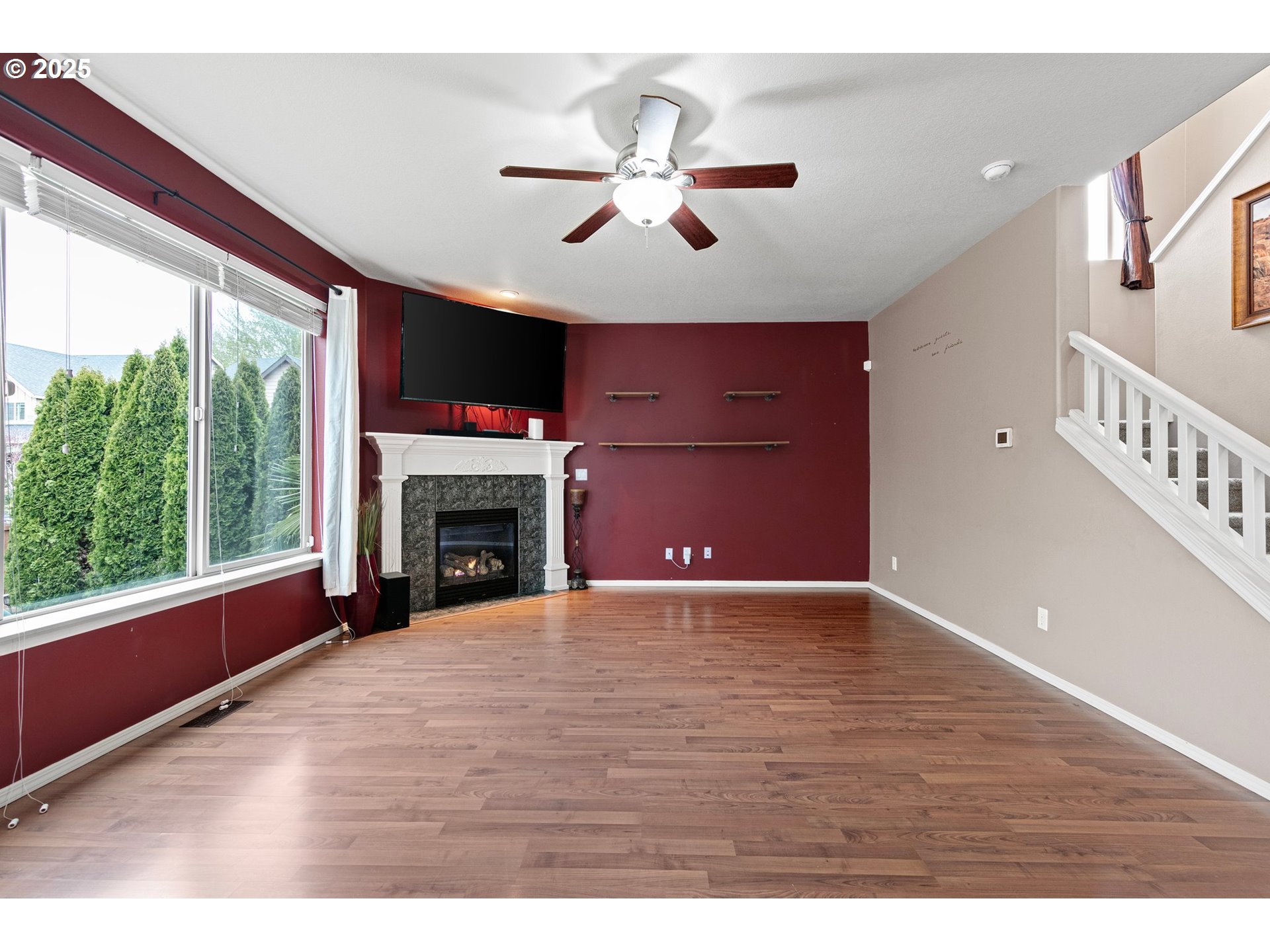 646 Raber Road Eugene, OR 97402 - Photo 10 of 44 a view of an empty room with wooden floor fireplace and a window