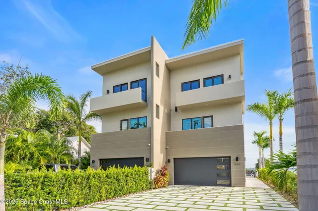 a view of a patio with table and chairs potted plants and palm tree