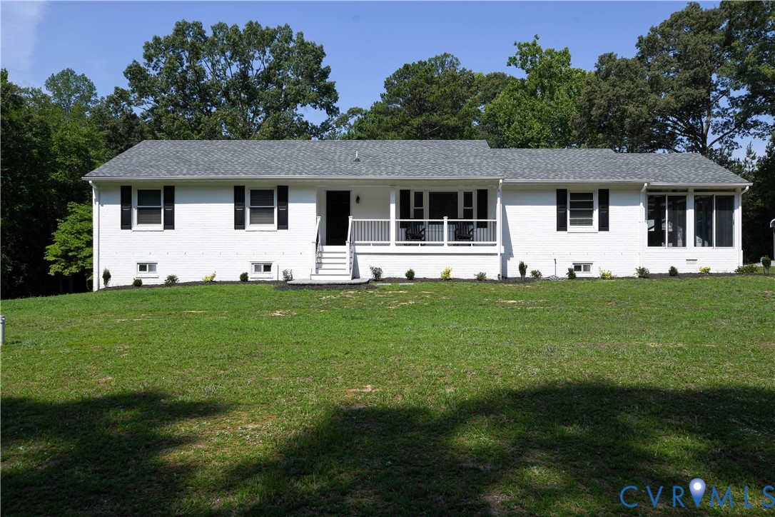 White brick ranch-style residence featuring a gray
