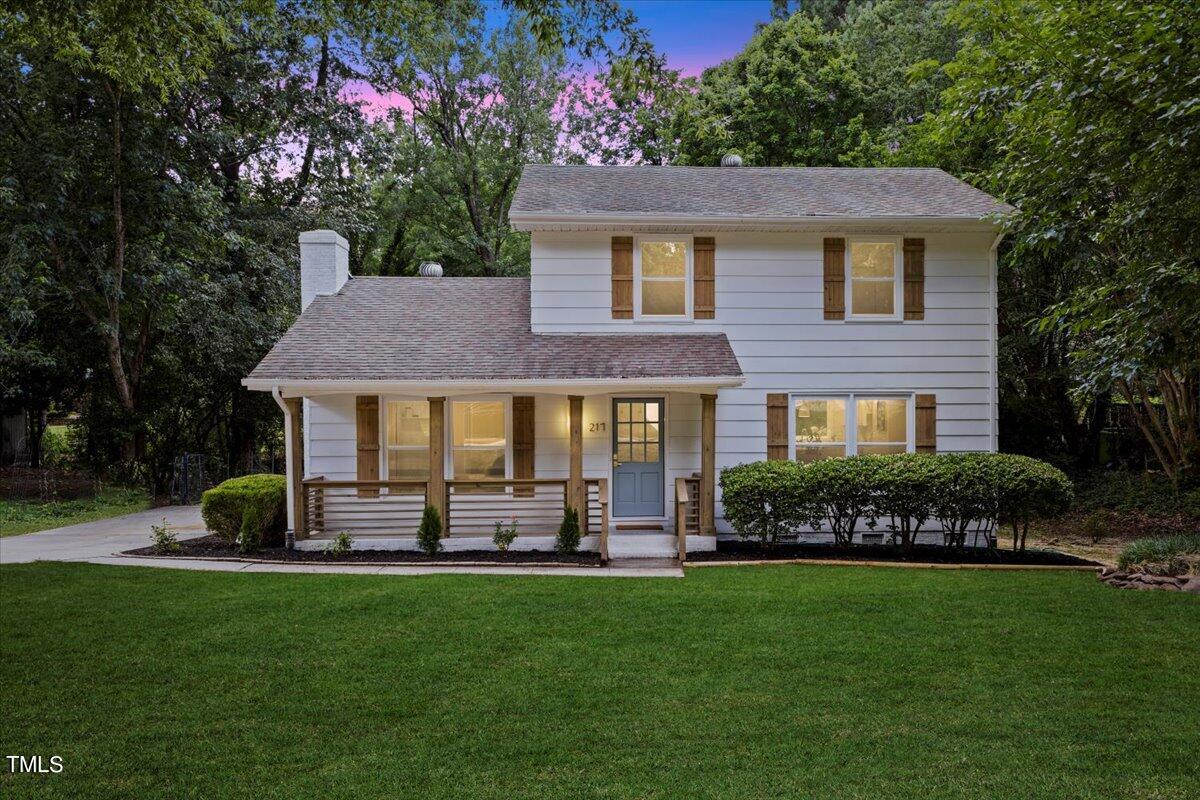 a front view of a house with a yard table and chairs